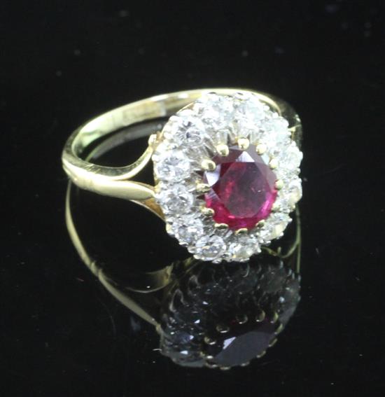 An 18ct gold and platinum, ruby and diamond oval cluster ring, size L.